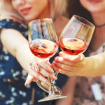 two glasses of wine, which girl friends hold having a wine celebrate friendship on picnic